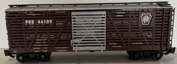 Aristocraft Steel Stock Car toy train model in brown, gray, and silver colors, with the name 'Pennsylvania Railroad' printed on the side.