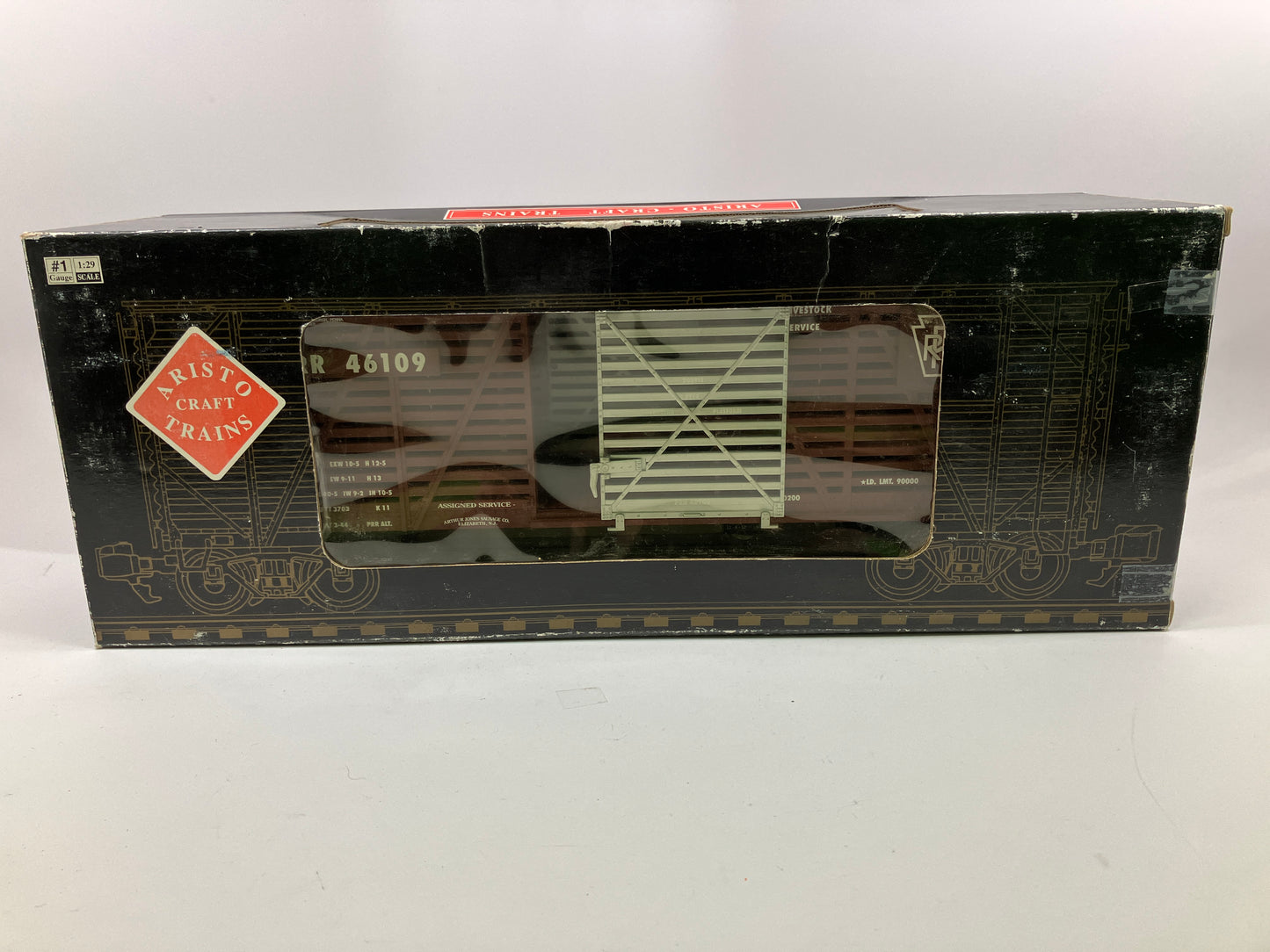 Aristocraft Steel Stock Car toy train model in brown, gray, and silver colors, with the name 'Pennsylvania Railroad' printed on the side.