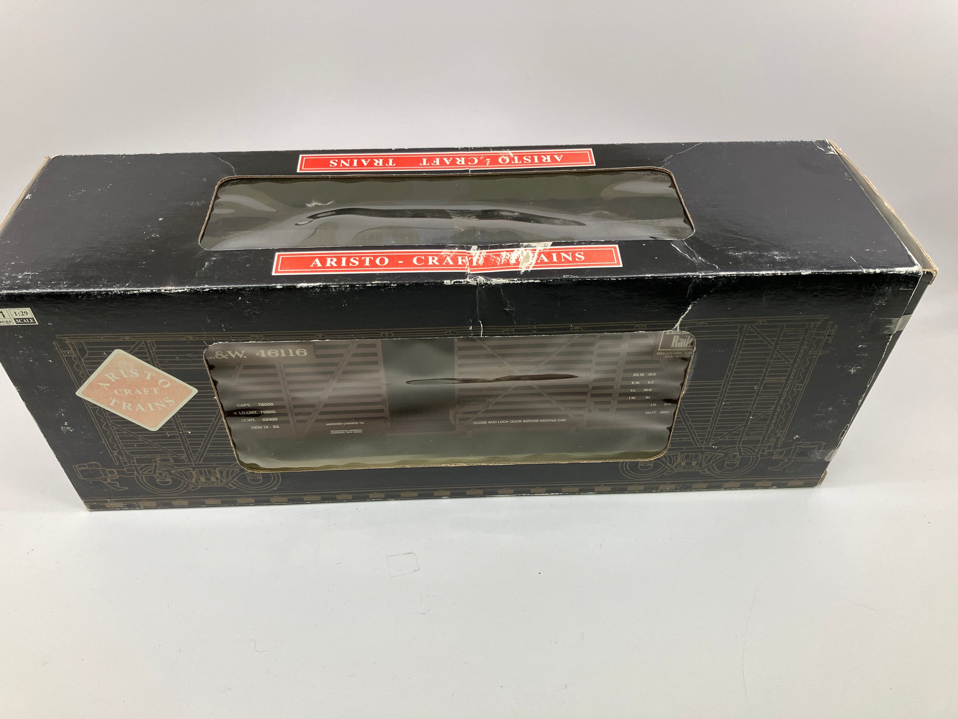 Red Aristocraft steel stock car toy train component, with the name 'Delaware Lakwanna & Western' printed on the side.