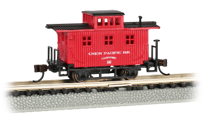 A Bachmann N scale model train, an Old Time Caboose in Union Pacific red livery, on tracks.