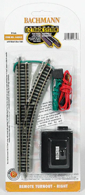Bachmann Scale System 8-ft. main line set in its original blister packaging, featuring a curved track section, a remote control, and a battery.