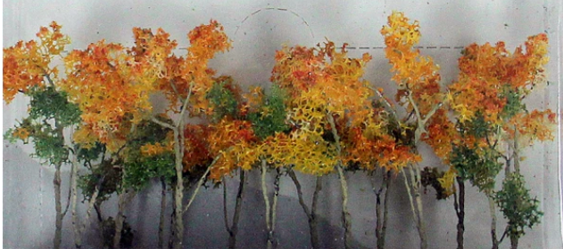 A set of model trees and shrubs with autumn-colored leaves for hobbyist train setups.