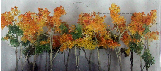 A set of model trees and shrubs with autumn-colored leaves for hobbyist train setups.