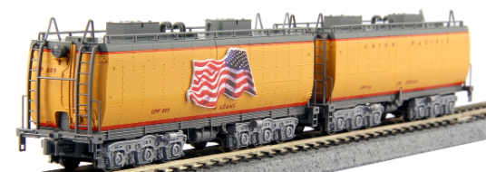 Model of a Kato brand water tender for a train set, colored in yellow and gray, with a decal of an American flag.