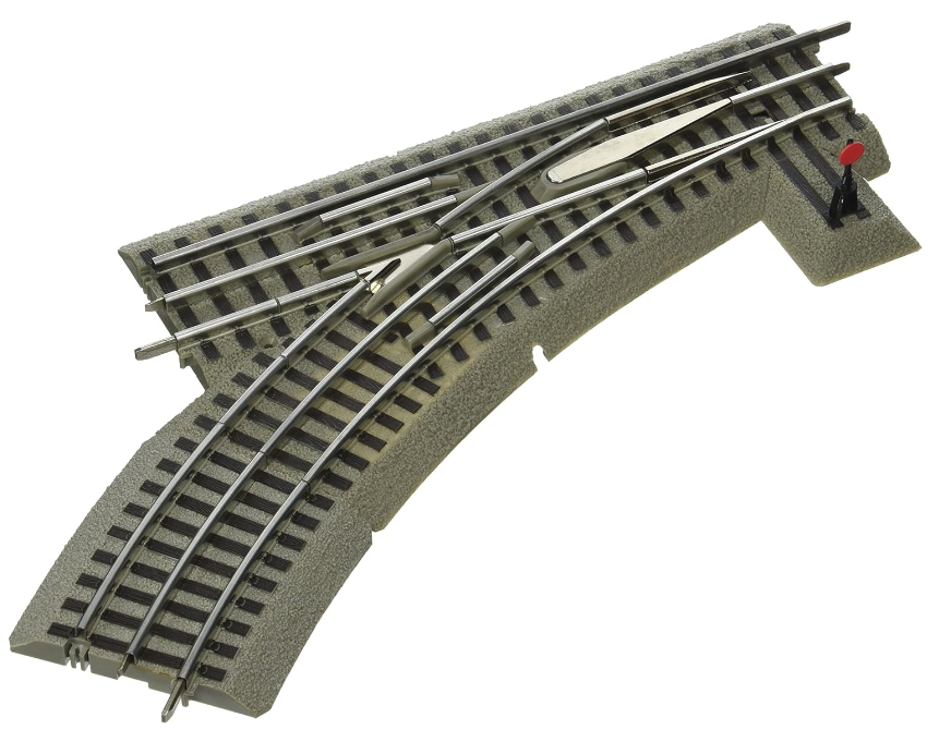 Lionel FasTrack 036 Manual Switch, consisting of a gray track section with metal switch components and a curved track guide.