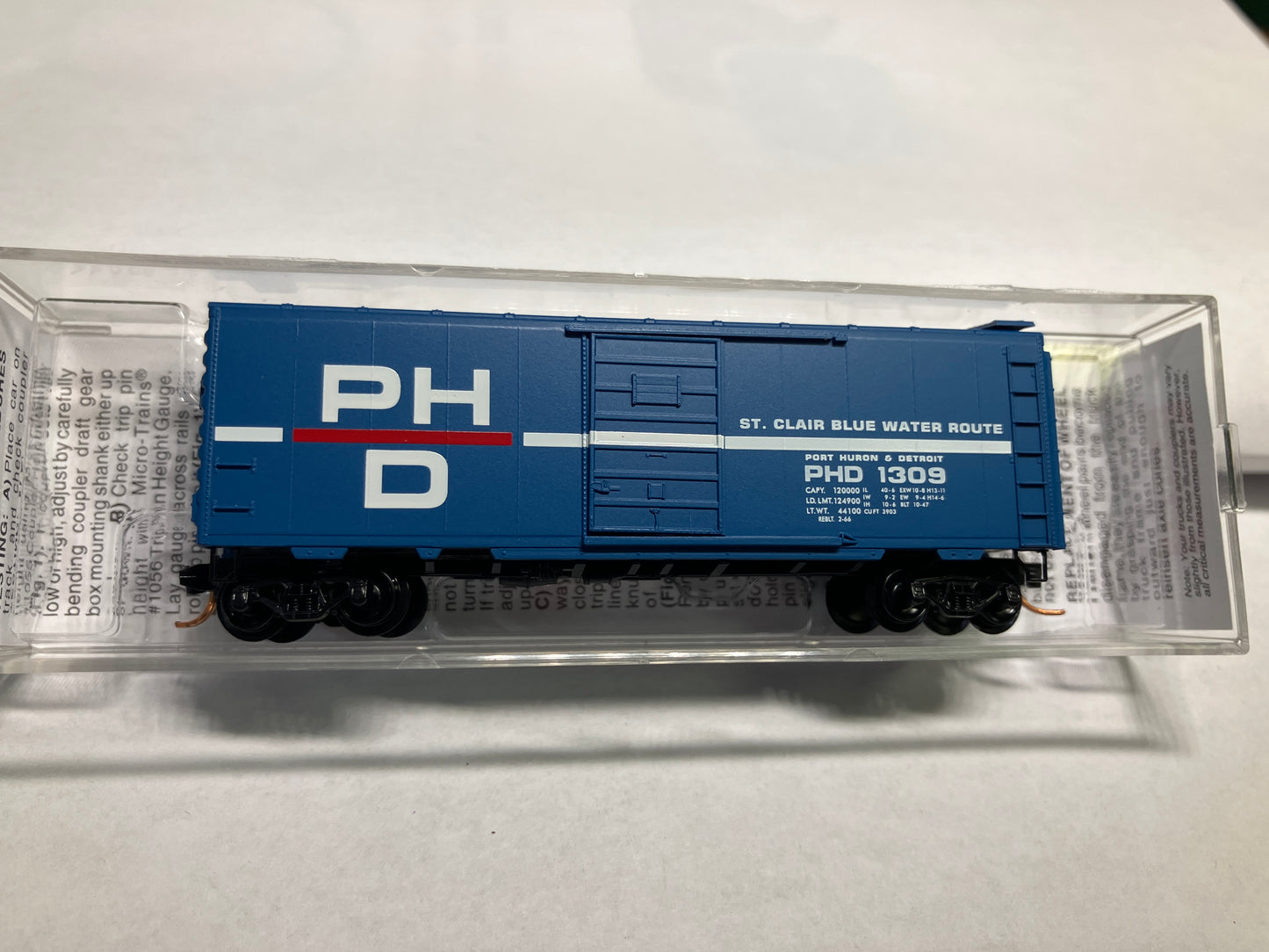 A blue and gray Micro Trains 02000150 Port Huron & Detroit 40' Standard Box Car model train car with a single door, displayed in packaging.