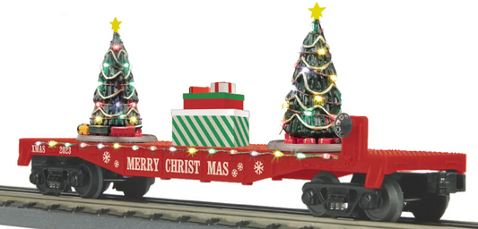 A red toy train car with lighted Christmas trees on its side, designed for use with O-27 curves.