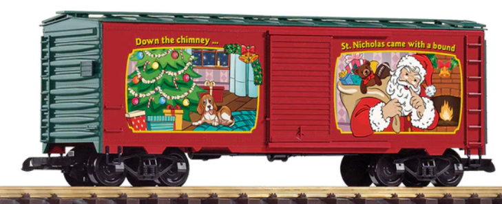 A red Christmas-themed model train car with festive decorations, including a Christmas tree and holiday-related imagery.