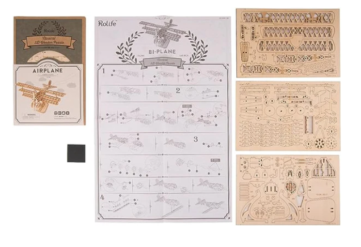 Wooden airplane model kit with instructions and parts on a white background