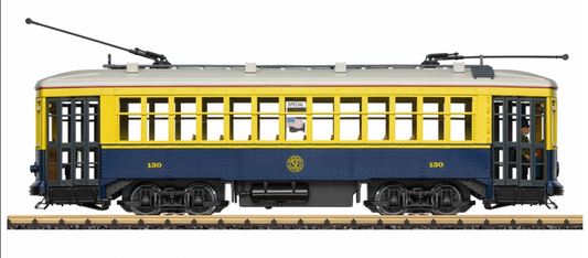 A model of a yellow and blue San Francisco streetcar with a number 130 on the side, displayed on tracks