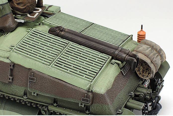 Close-up of a model tank with detailed components on a white background