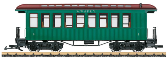 A model of a green Wiscasset, Waterville & Farmington Railway passenger car with metal wheels and opening doors.