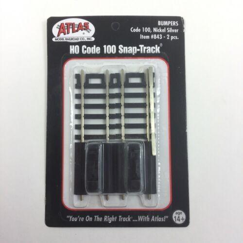 Packaging of Atlas 843 HO Code 100 Snap-Track Nickel Silver Track Bumpers with two pieces visible inside.