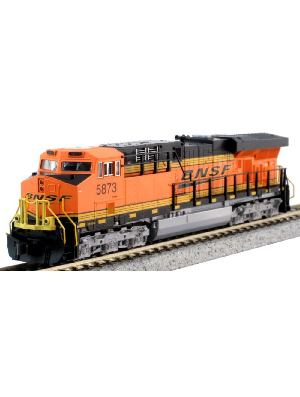 Model of a KATO N scale diesel locomotive with orange, black, and yellow coloring, numbered 5977, on tracks