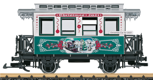 A model of a Christmas-themed train car with a green and silver color scheme, featuring festive decorations and the text 'Christmas 2021' on its side.