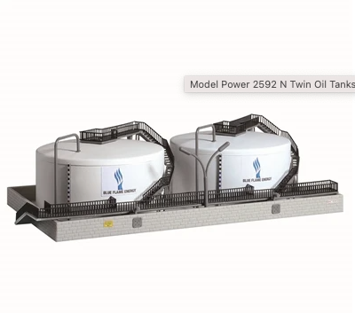A model of twin oil tanks with a train model, predominantly white and black in color, with a label indicating 'Model Power 2592 N Twin Oil Tank'.