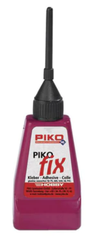 A bottle of PIKO-Fix plastic cement in a red color with a black cap. The label includes the brand name and product type.