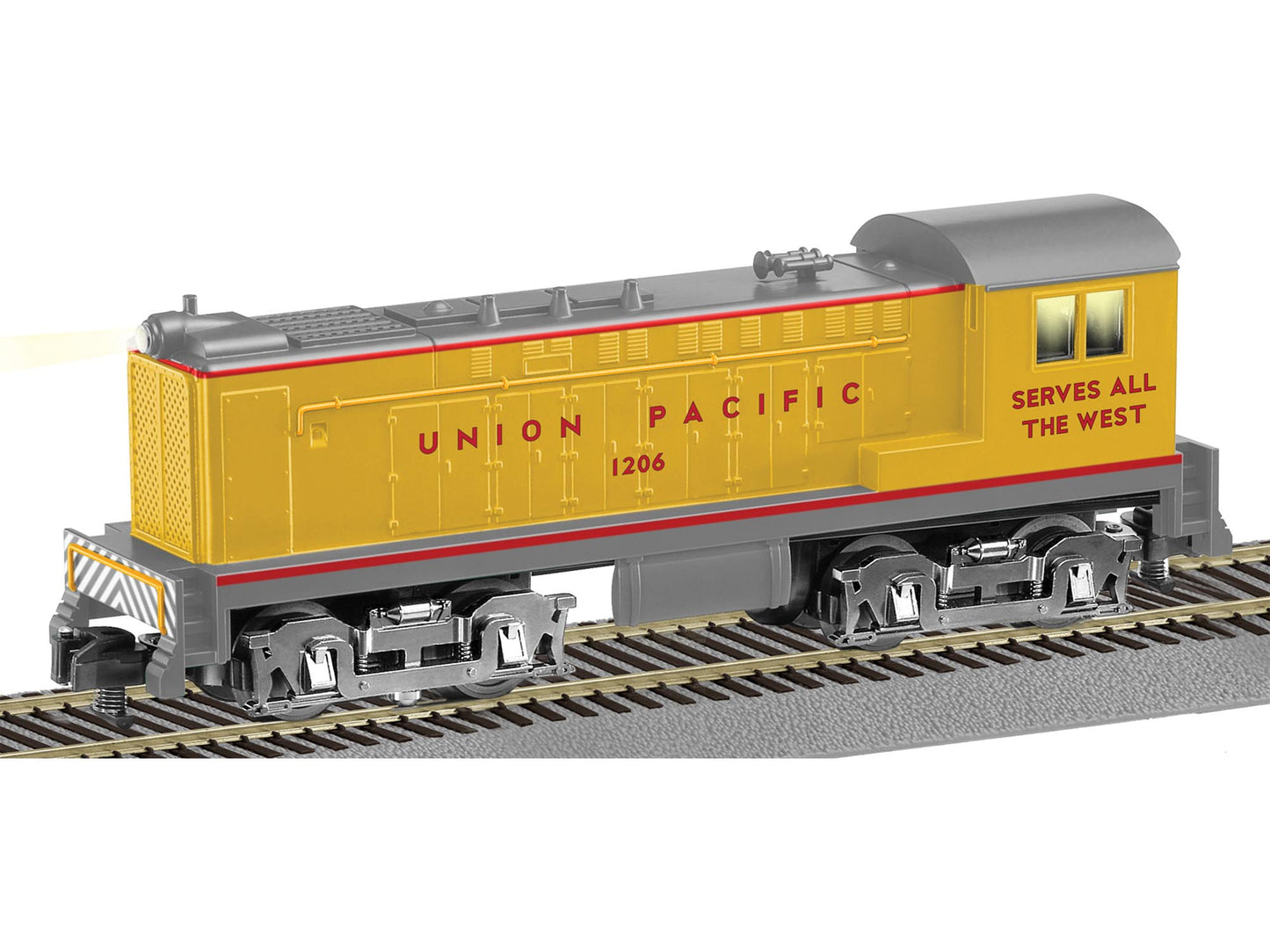 A traditional Union Pacific Baldwin switcher model train in yellow color with red and gray accents, labeled with 'SERVES THE WEST' on the side.