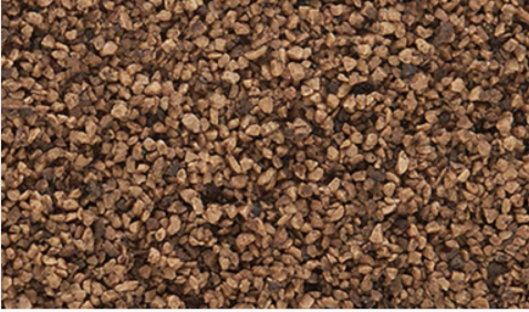 A close-up view of brown fine shaker granules.