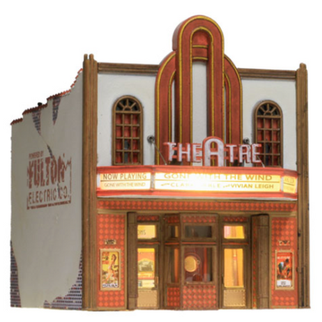 A model of a vintage theater with a stucco-over-brick exterior, gilded kick plates, and a decorative tile facade, equipped with window treatments and decals, as well as a lighted marquee.