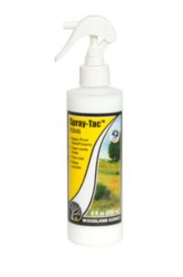 A bottle of Spray-Tac adhesive spray with a fine mist nozzle, intended for use with flowers and plant hues.