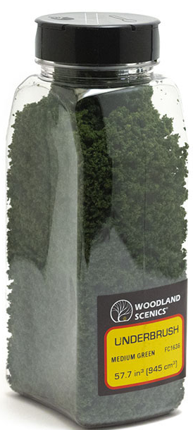 A package of Woodland Scenics model train foliage, featuring medium green color and designed for use in model train setups.