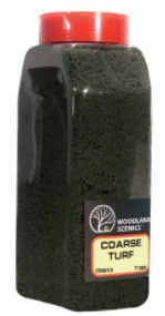 A plastic shaker container of Woodland Scenics coarse turf, designed for model train setups.