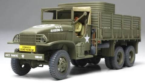 A detailed model of a vintage military cargo truck in olive drab green with white star insignias and white text markings, shown on a neutral gray background.
