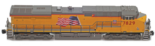 Model train locomotive with UP logo and American flag on an orange background