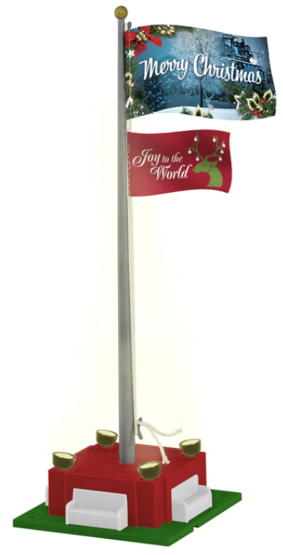 A Christmas Joy flagpole with two flags, designed for an O scale model train setup. The flagpole has a metallic appearance with a red and green Christmas-themed flag.