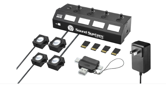 Sound System Sound Hub multi-channel audio interface kit with four speaker inputs, four input jacks, four SD cards, a USB adapter, and a power adapter on a white background.