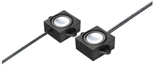 Two small black square electronic components with circular silver centers, connected by thin black wires on a plain white background.
