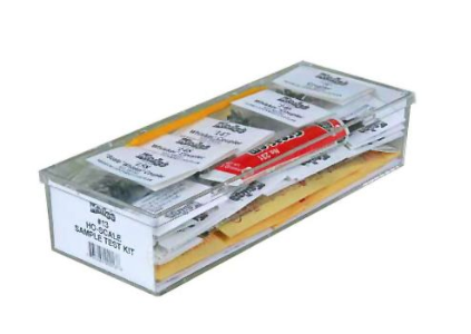 A display box containing various model train coupler parts and accessories, with labels and packaging.