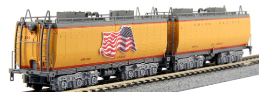 Model of a Kato brand water tender for a train set, colored in yellow and gray, with a decal of an American flag.