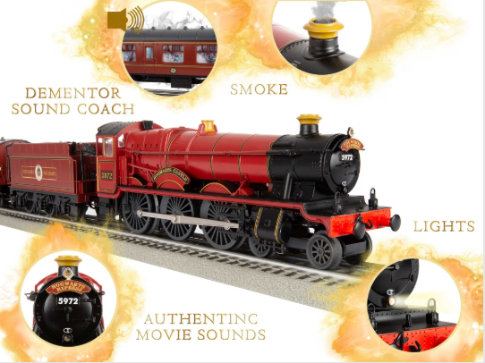 Toy train set with red engine and black carriages on tracks, featuring smoke, lights, and authentic movie sounds.