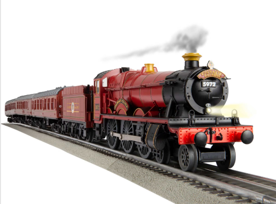 Model steam train on tracks with a white background