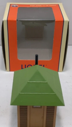Model of a green roofed building with a box in the background