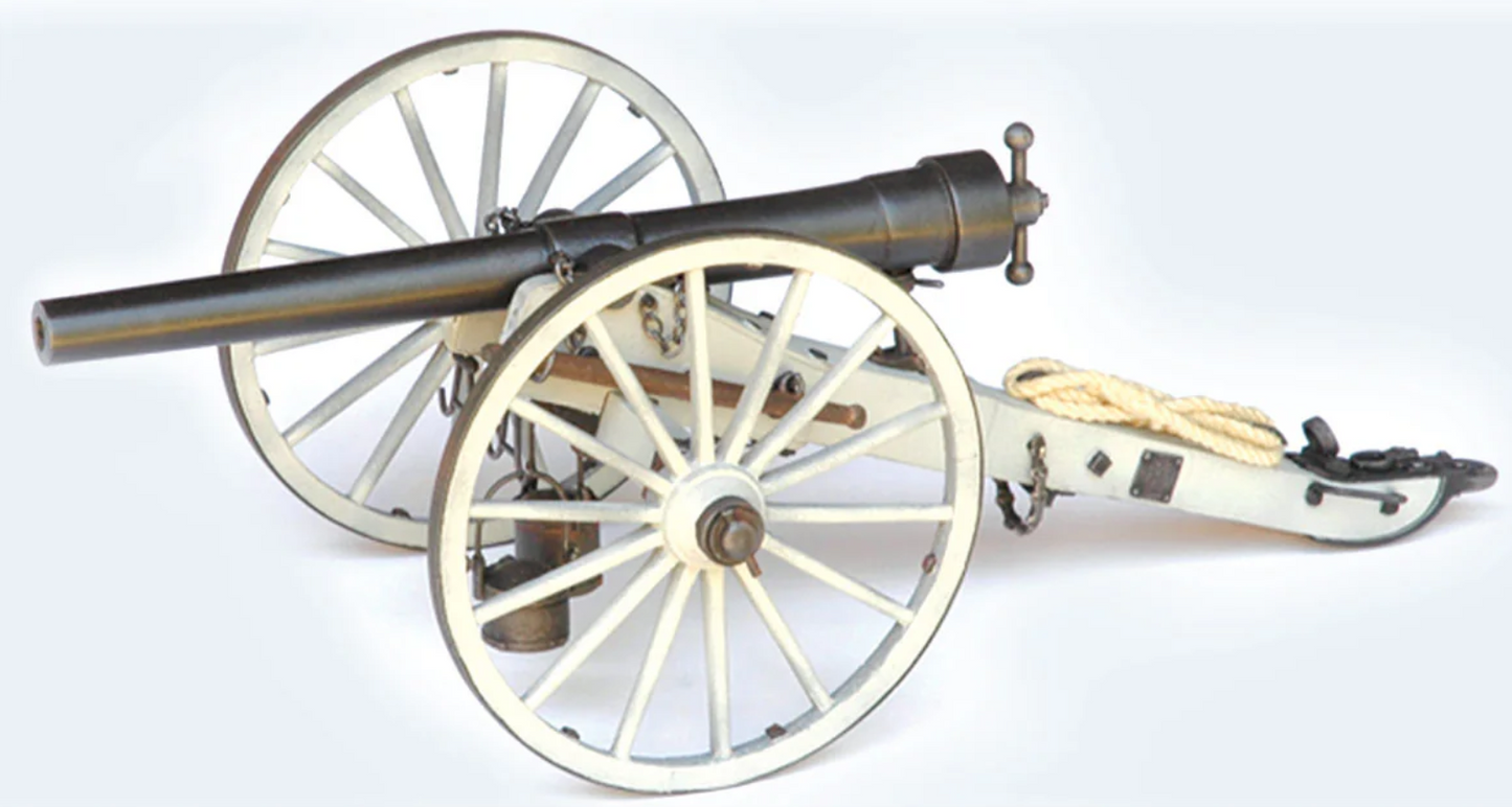Model cannon on wheels with a white background