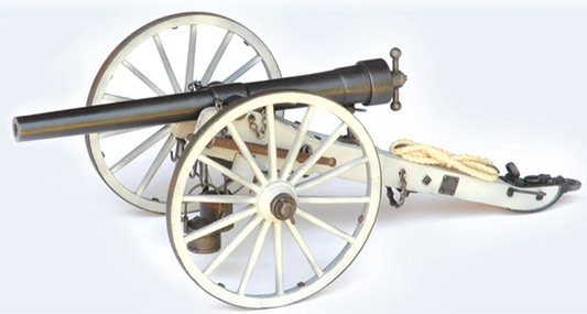 Model cannon on wheels with a white background