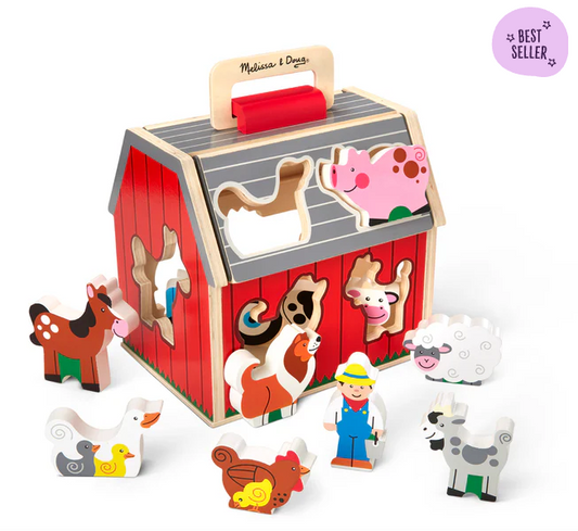 Wooden farm animal puzzle set with barn-shaped box and various farm animals on a white background.