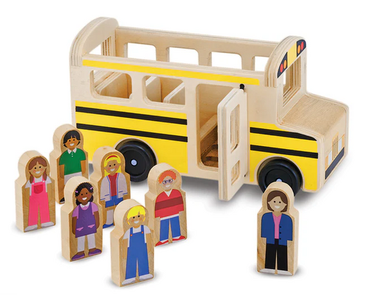 Wooden toy school bus with multiple figures on a white background
