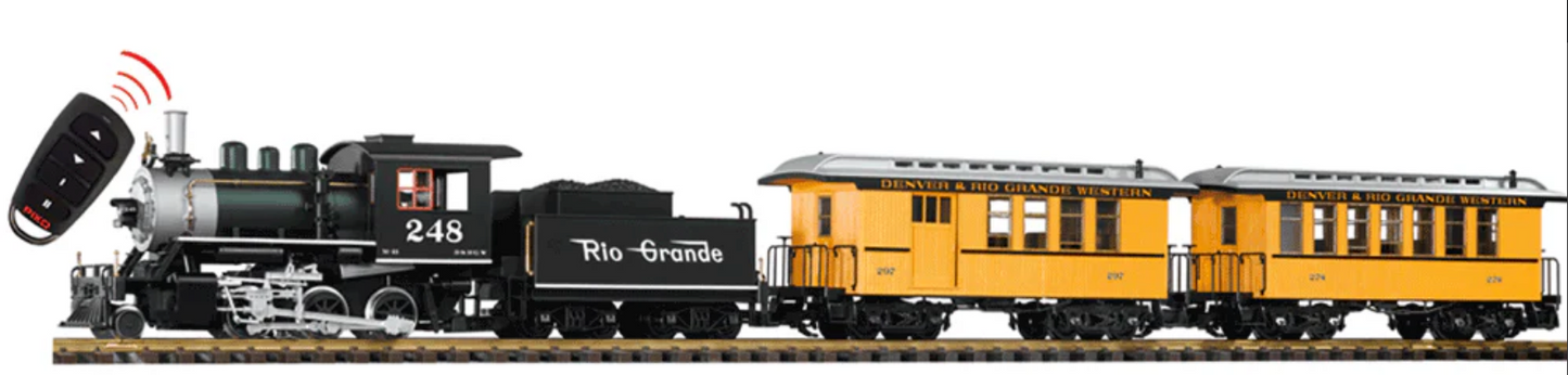 Model train set with steam locomotive and passenger cars on a track, featuring Rio Grande branding.