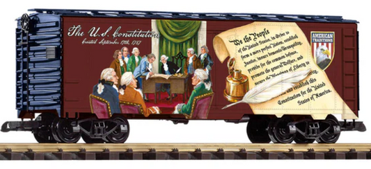 Model train car with a design of the U.S. Constitution and founding fathers, on a track.
