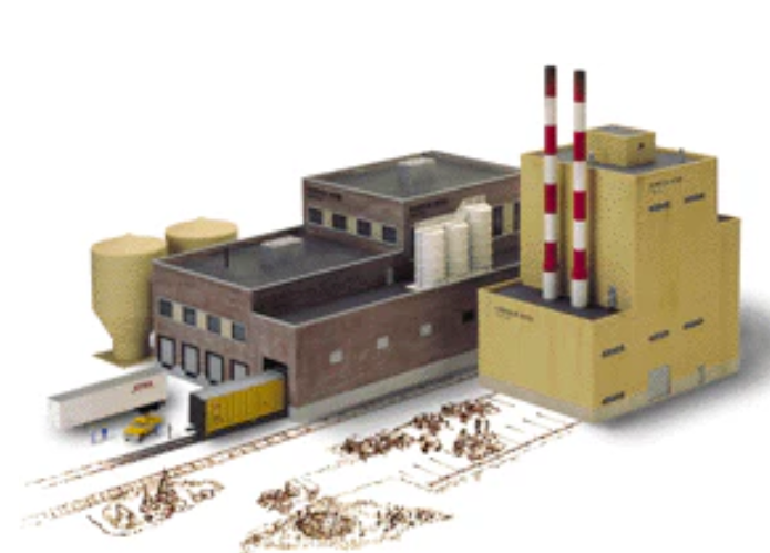 A miniature model factory and yard set, featuring a brown brick factory building with two red-and-white striped smokestacks, a yellow warehouse, silos, and a small train with a freight car on tracks, isolated on a white background.