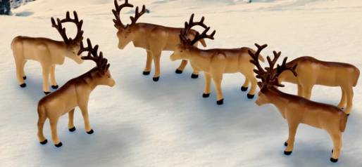 A set of six beige caribou animal pack figures for an O scale model train set, depicting a scene from the movie 'The Polar Express'.