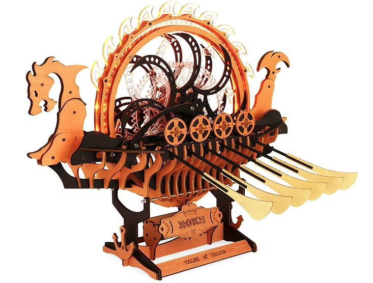 Wooden model of a Viking longship with sails and oars on a white background