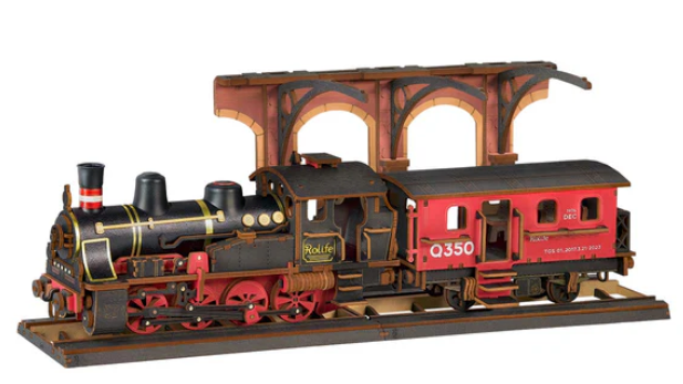 Model train set with a steam locomotive and red passenger car on a white background