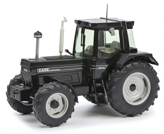A black Schuco CASE IH 1455 XL 1:32 scale diecast collector model tractor with four wheels and a visible interior.