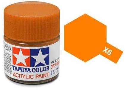 A bottle of Tamiya acrylic paint in orange color, labeled 'X-6', with a removable cap, displayed alongside a graphic representation of a honeycomb pattern.