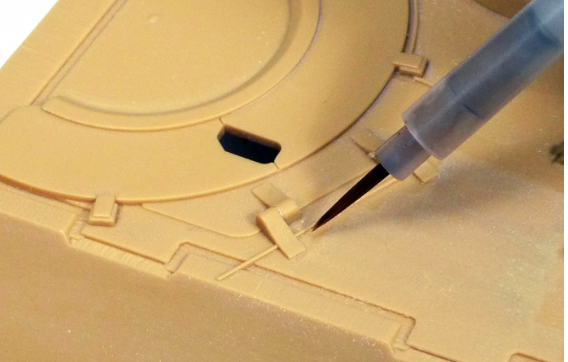 Model kit with a tool being used to cut or shape it